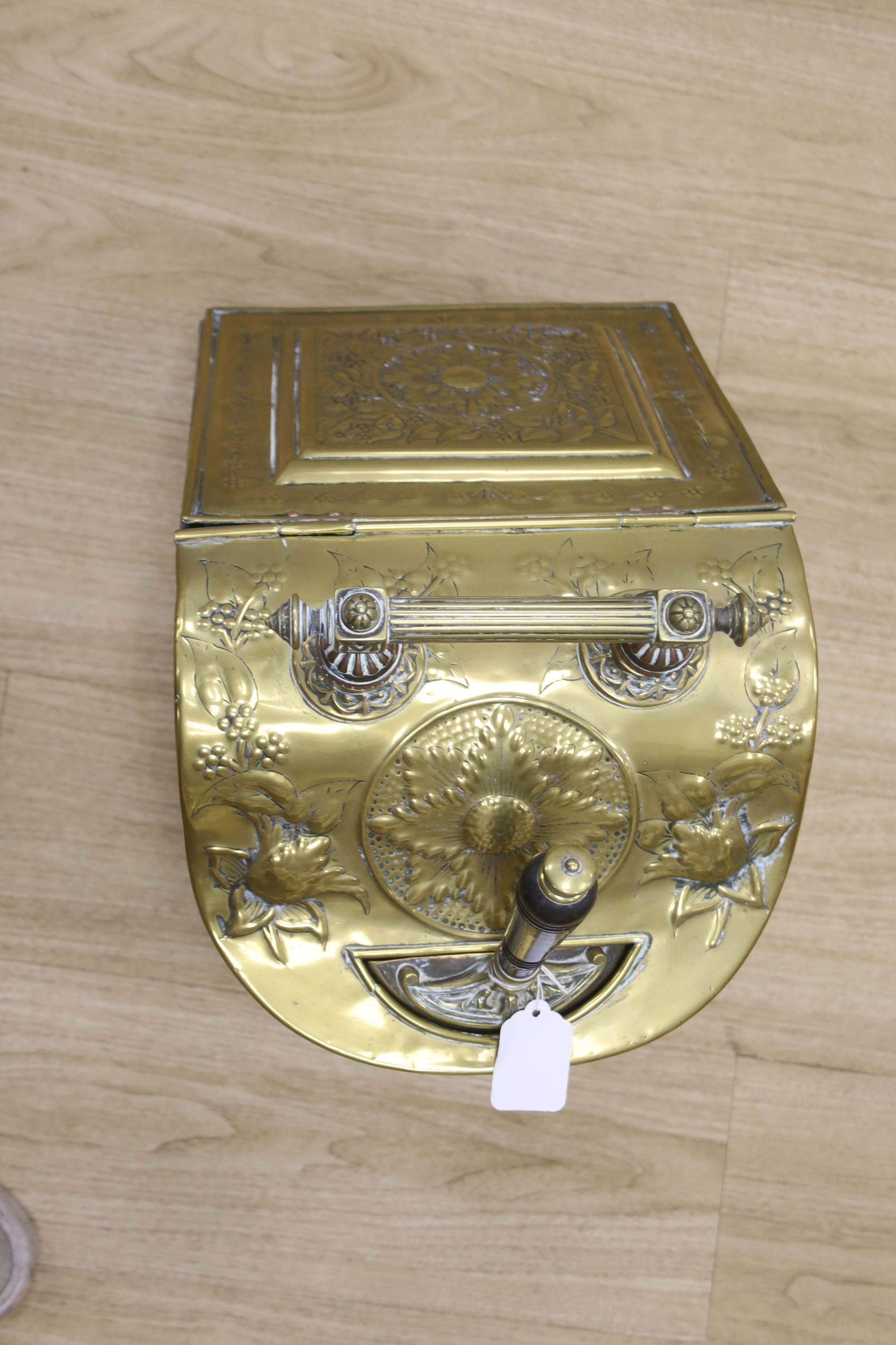 A Dutch embossed brass coal scuttle